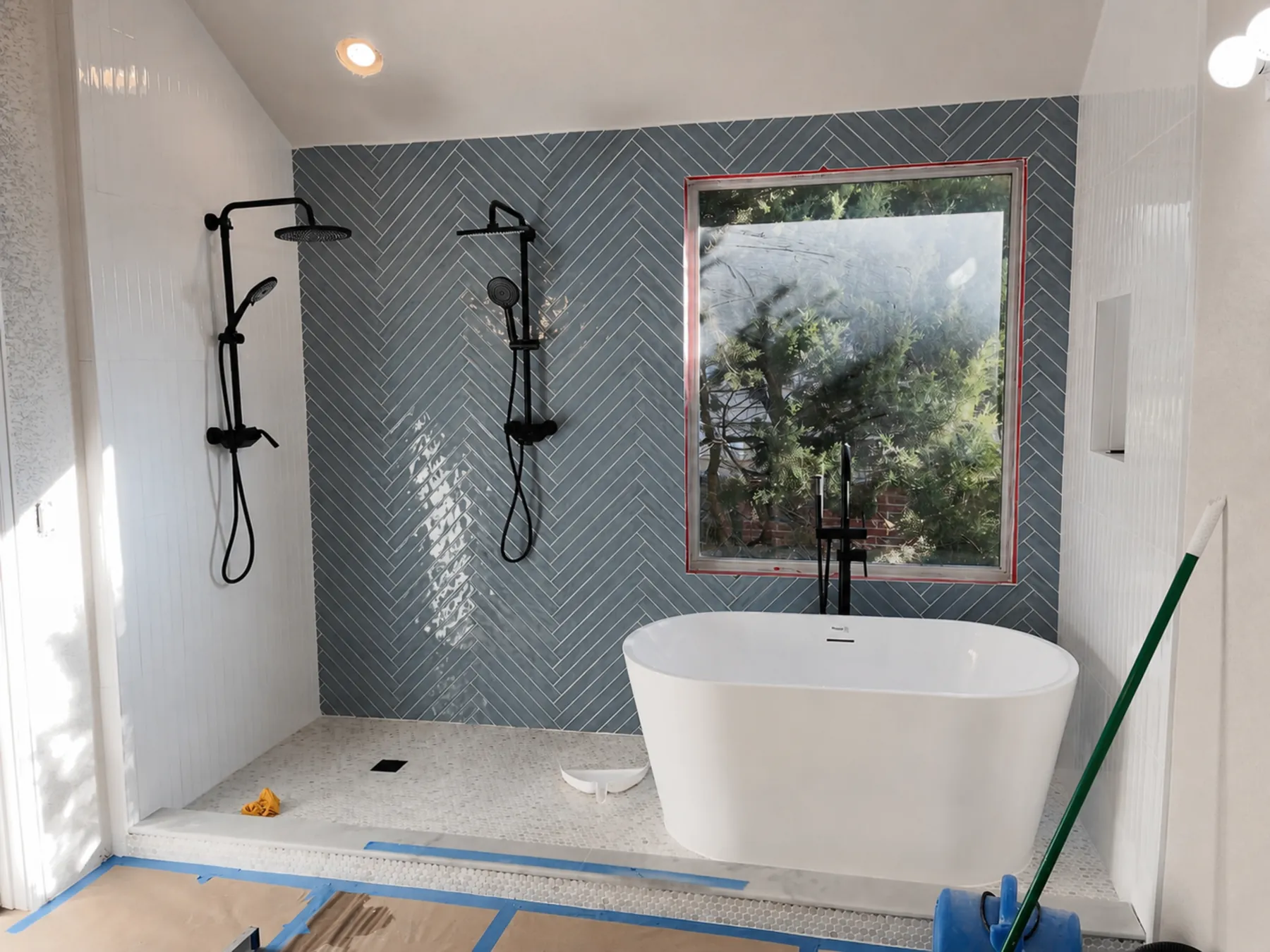A primary bath during construction, with the shower tile going in