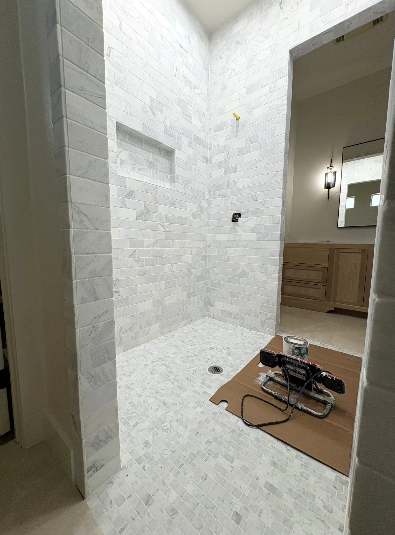 Marble shower walls and a mosaic floor going in.