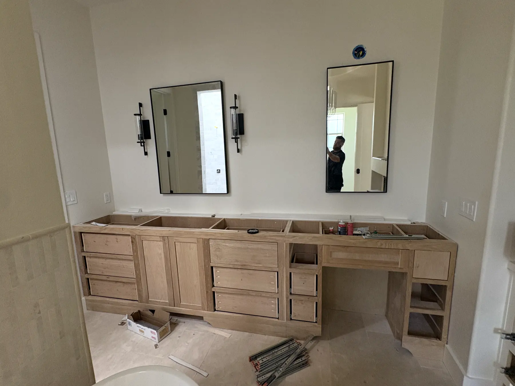Vanity cabinetry set, with the mirrors and sconces up. Counters come next.