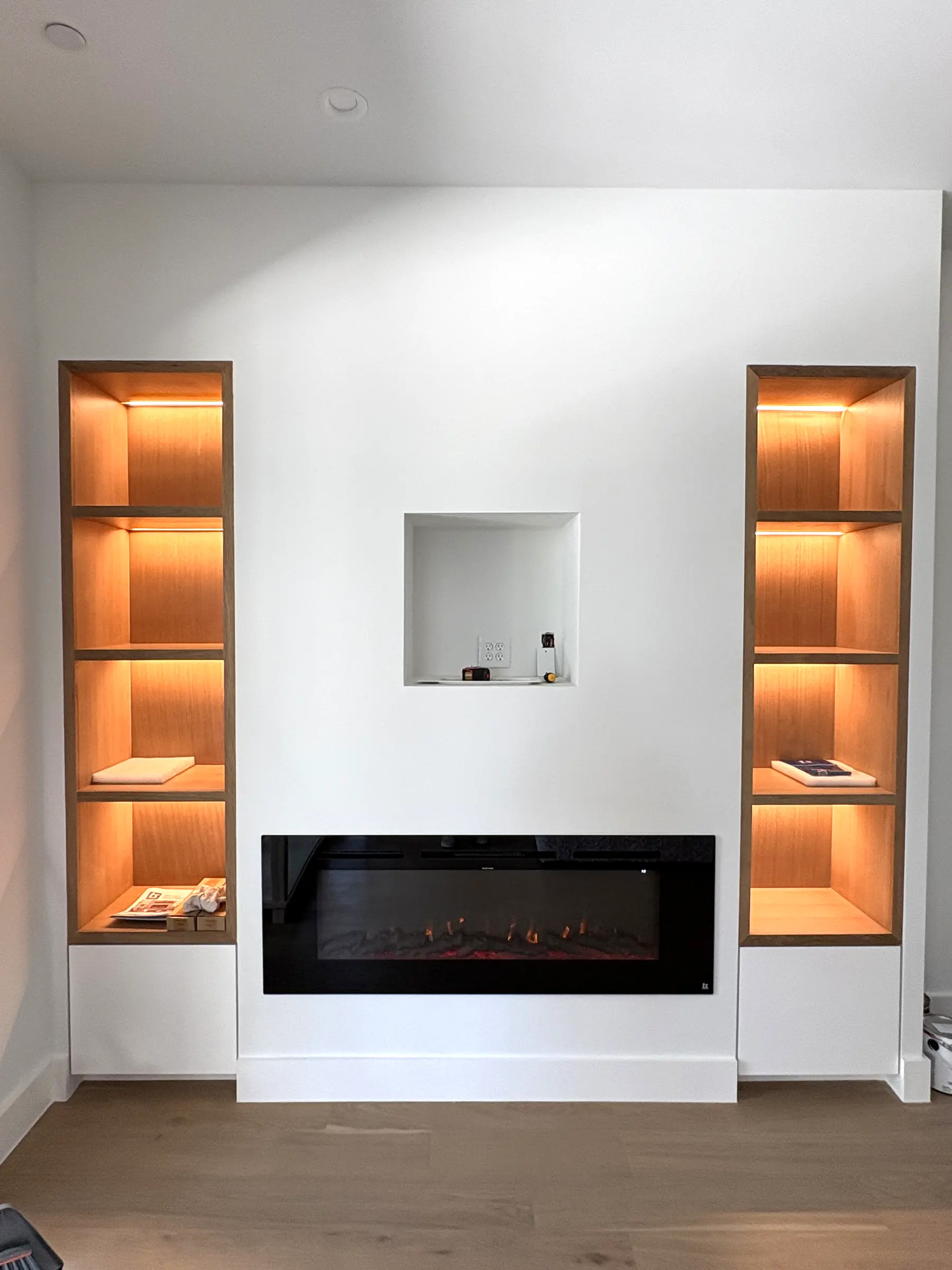 As built. The fireplace, the lit shelves and the niche above are in. Styling comes next.